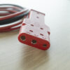 Photo of a 3-pin connector of a GPU cable, especially for use with the TowFLEXX TF1 and TF2 aircraft tugs. The plug is clearly visible and in focus, with clearly recognizable connections and a robust design that ensures a reliable and secure connection
